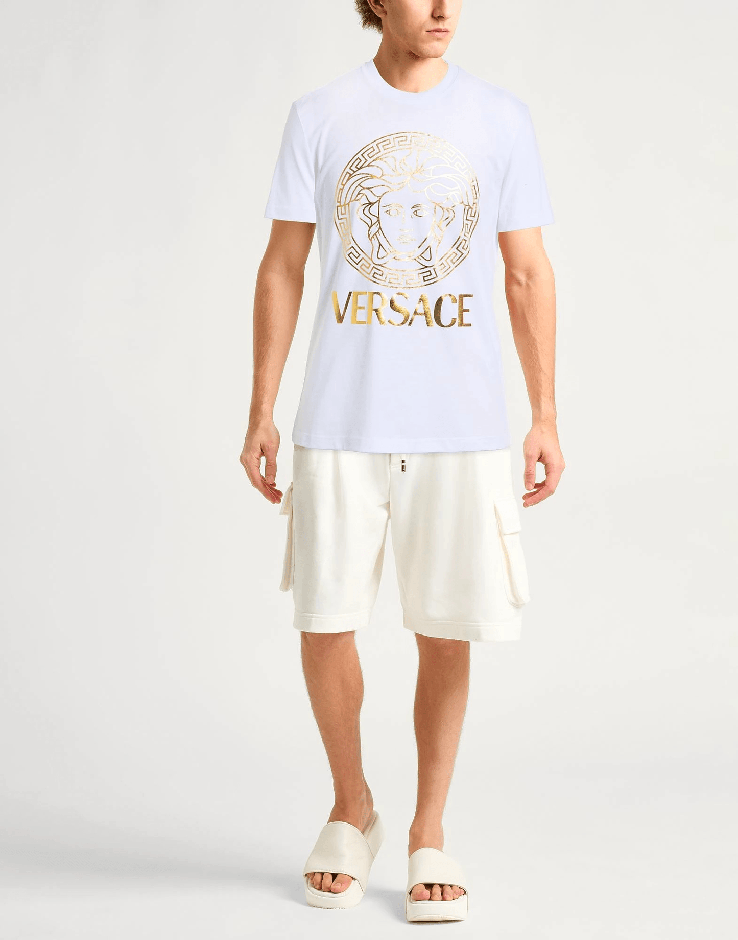 Versace T-Shirt Jersey Metallizzato Bianco 210Y10X02X100 con logo dorato e design iconico su sfondo bianco.